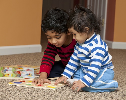Children playing with a puzzle on the floor