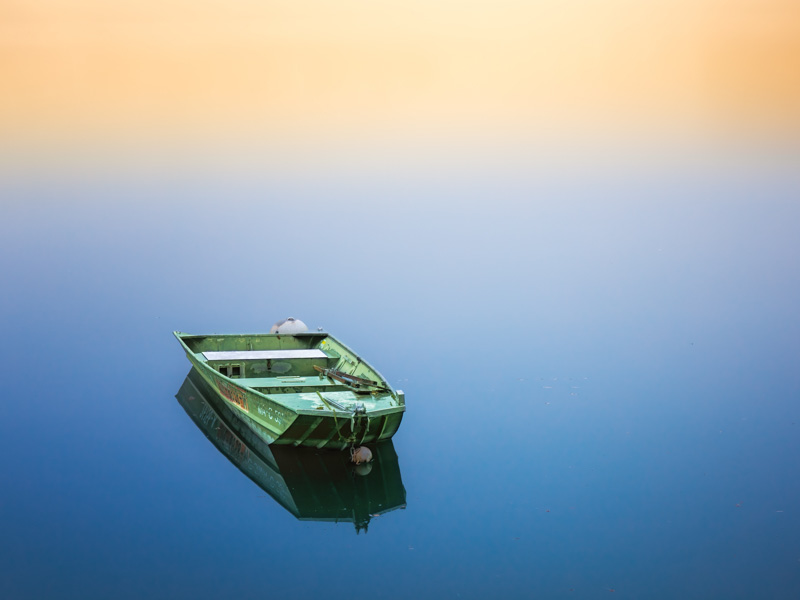 Boat floating on calm waters